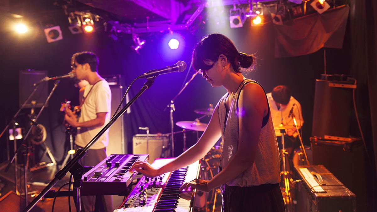 Young people in a music venue playing music