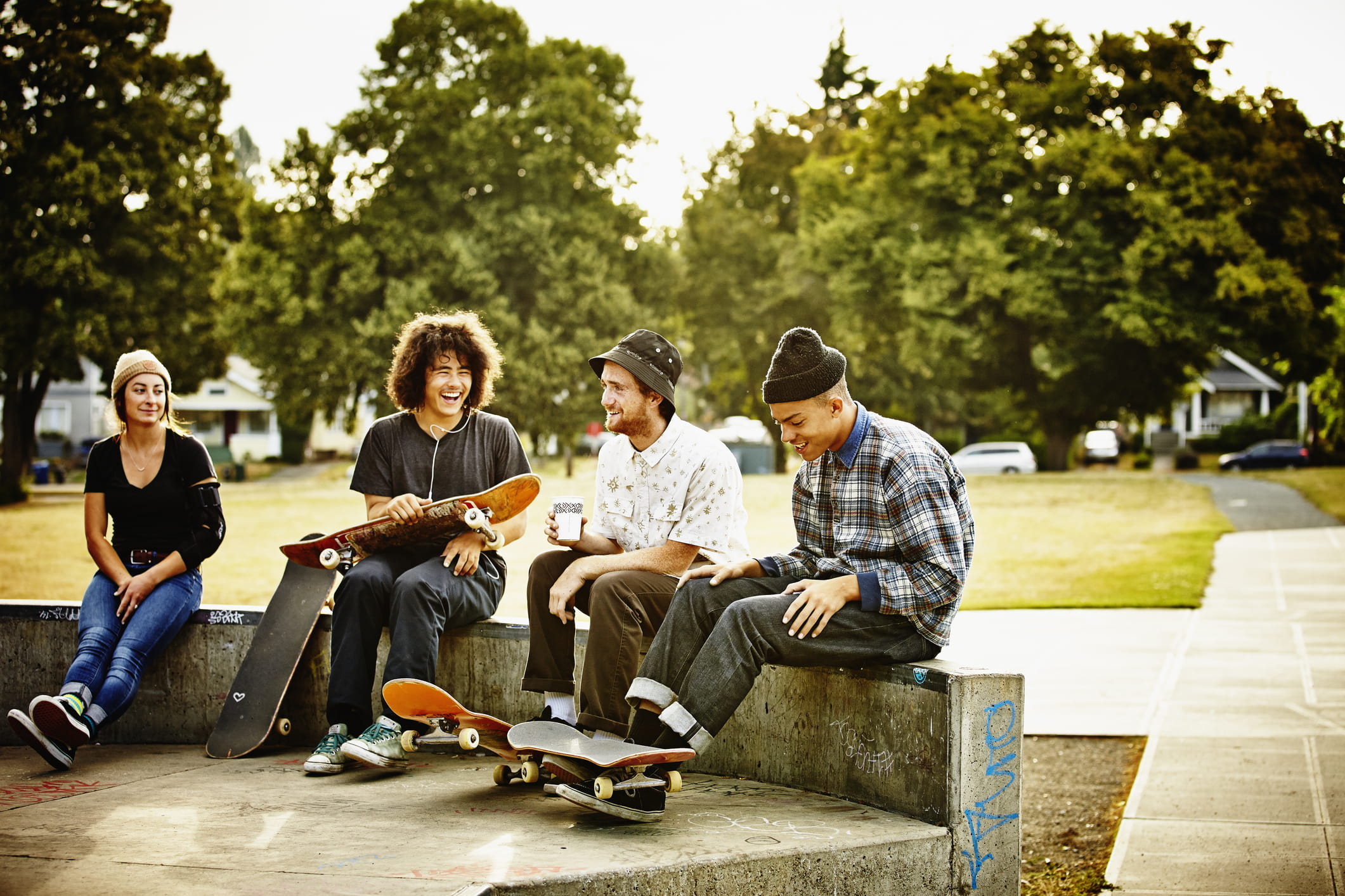 Group of young people at a skate park having a laugh