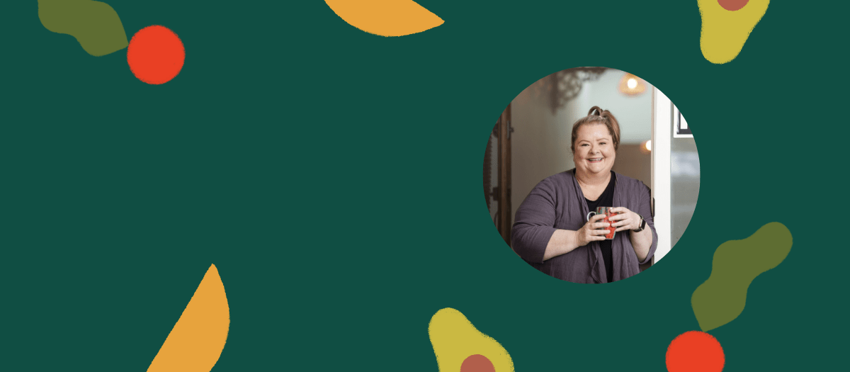 Picture of Magda Szubanski holding a mug and smiling on a green background