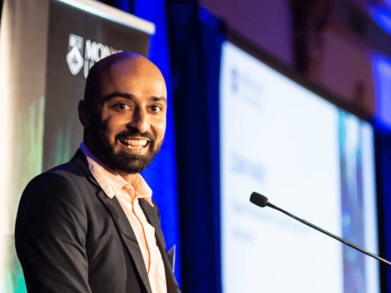 Zain Nabi from SBS's 'The Disruptive Companion' podcast, speaking at a lectern