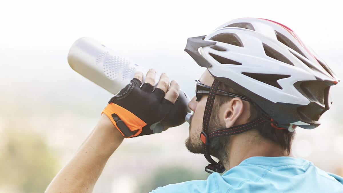 Cyclist drinking from water bottle