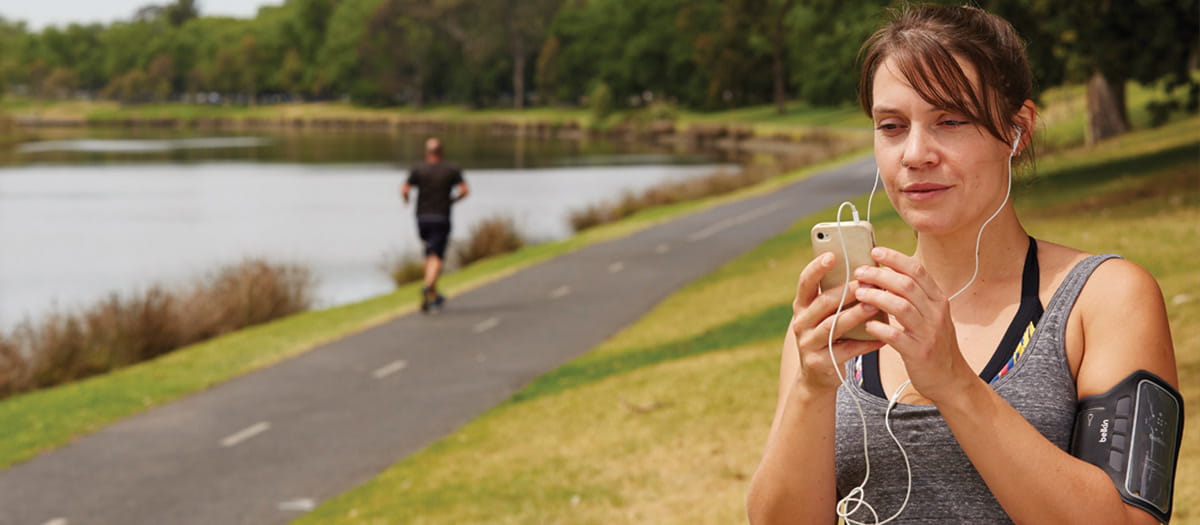 Woman in exercise clothes looking at phone