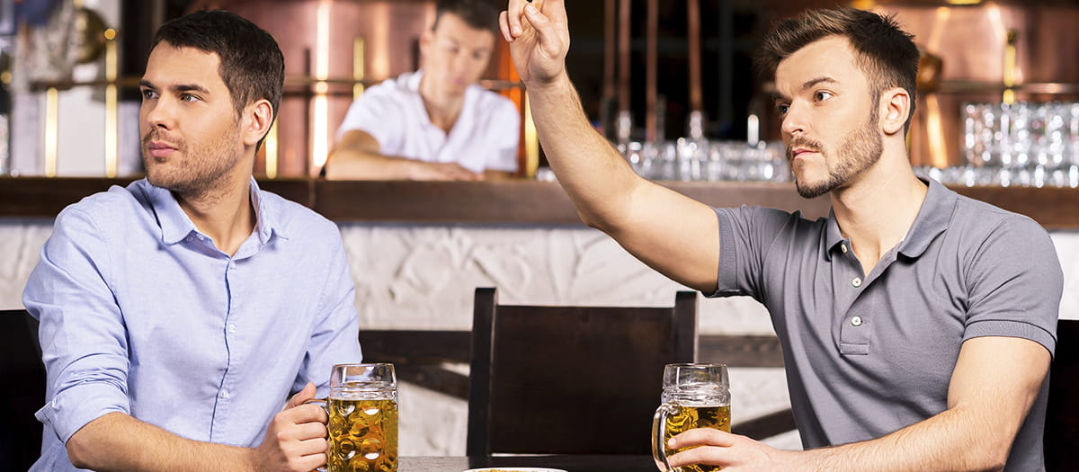 Men ordering drinks at a pub