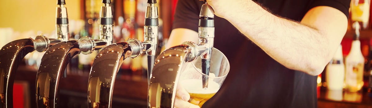 Bartender pouring beers at a pub
