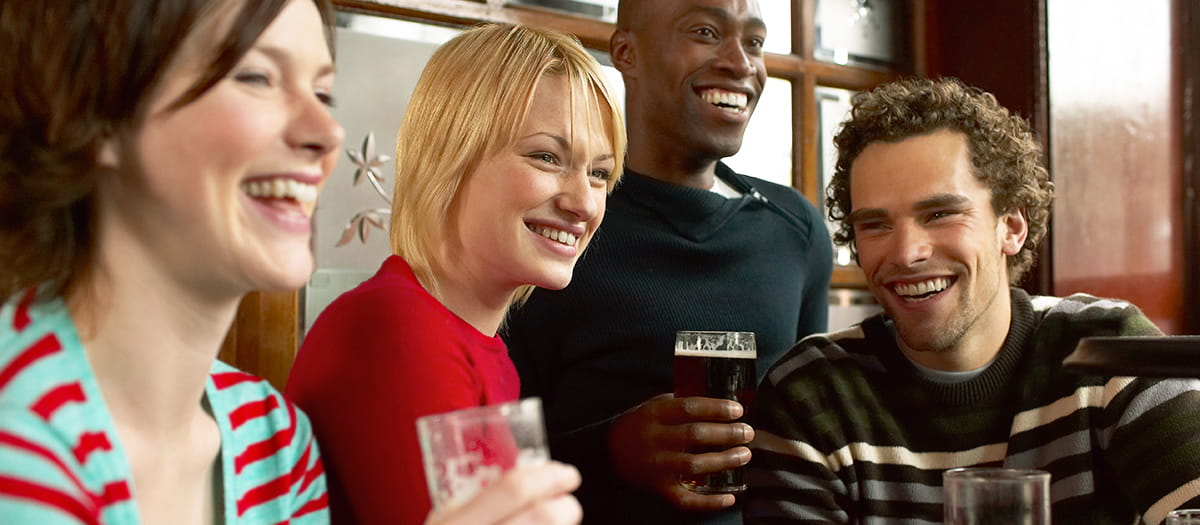 Young people drinking at a pub together