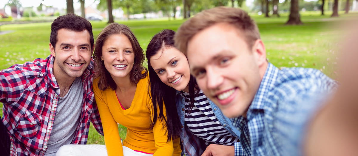 Friends posing for a photo in a park