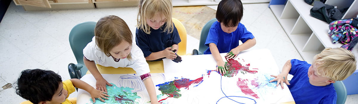 Children painting pictures at school