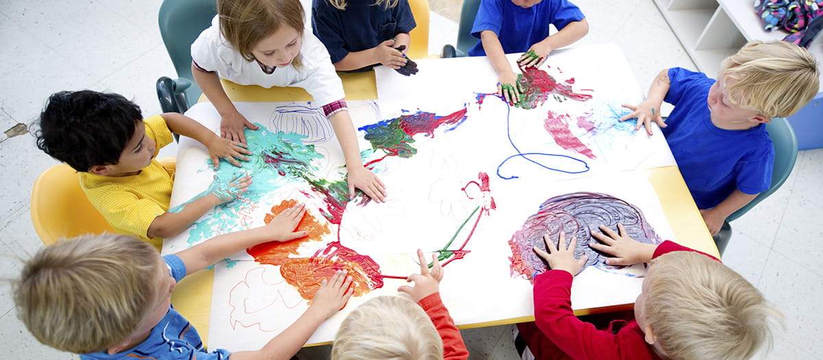 Children painting pictures at school
