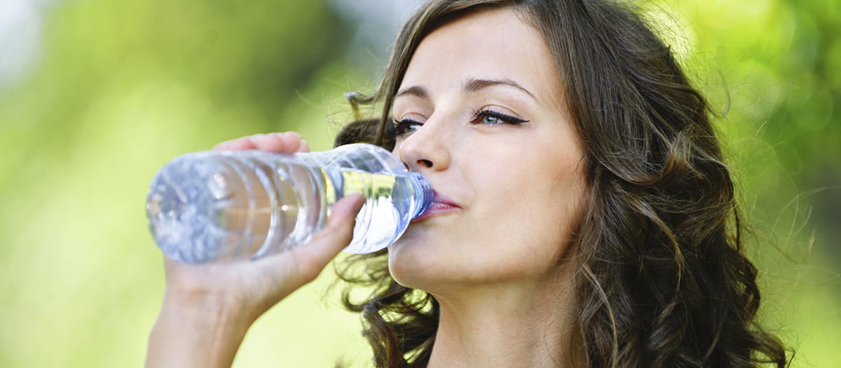 Young woman drinking from a water bottle