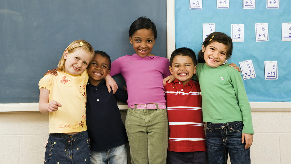 Children from various ethnicities in a classroom together