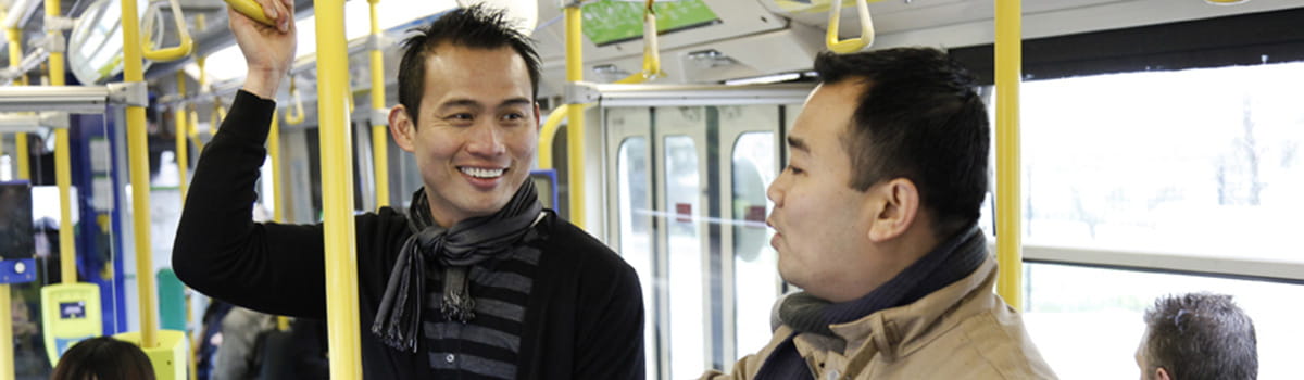 Two men of various ethnicities on a train in Melbourne