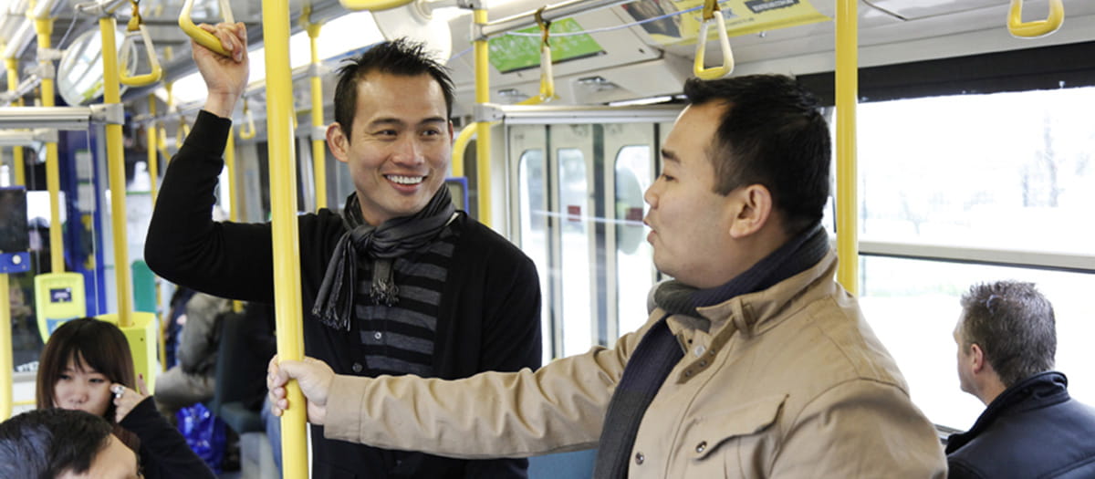 Two men of various ethnicities on a train in Melbourne