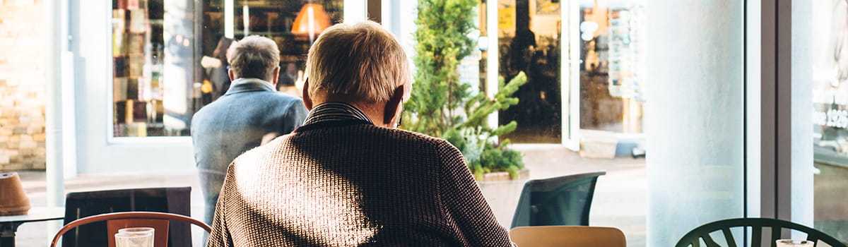 Older man in a cafe alone
