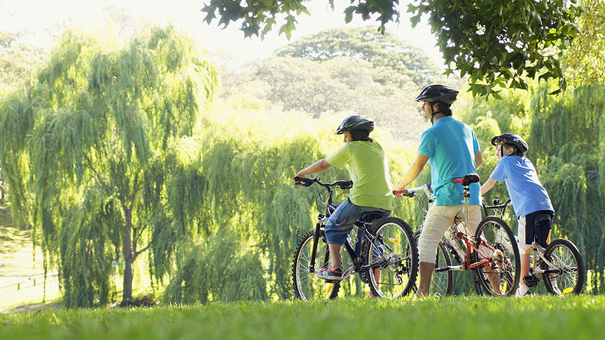 Family cycling in a park