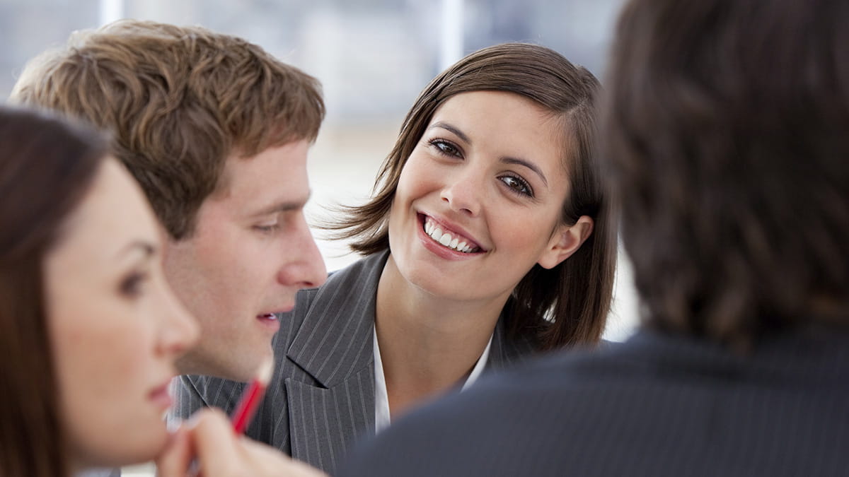 Woman smiling in an office meeting