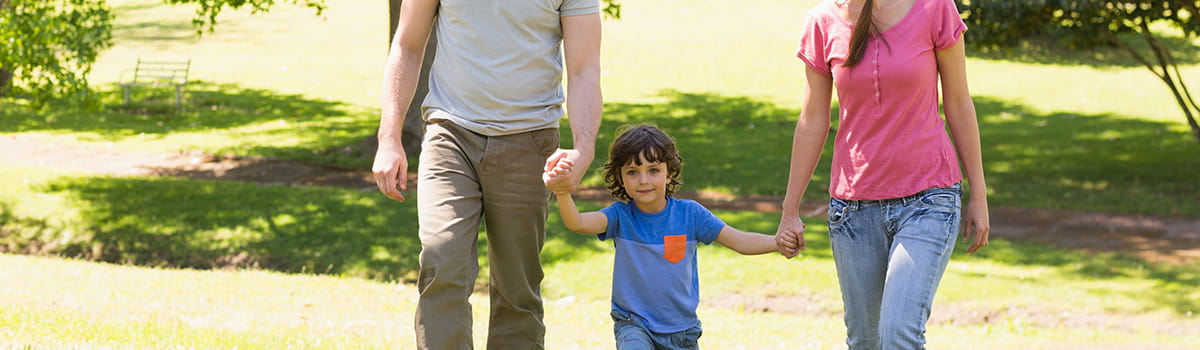 Parents walking with their child