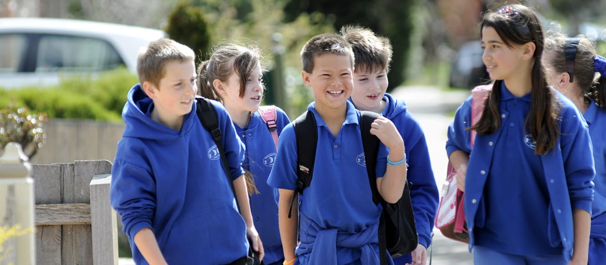 Group of children in school uniforms walking together