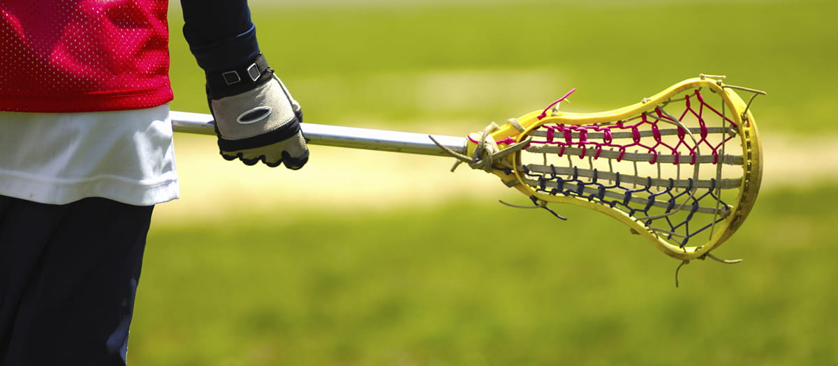 Teenager holding a lacrosse stick