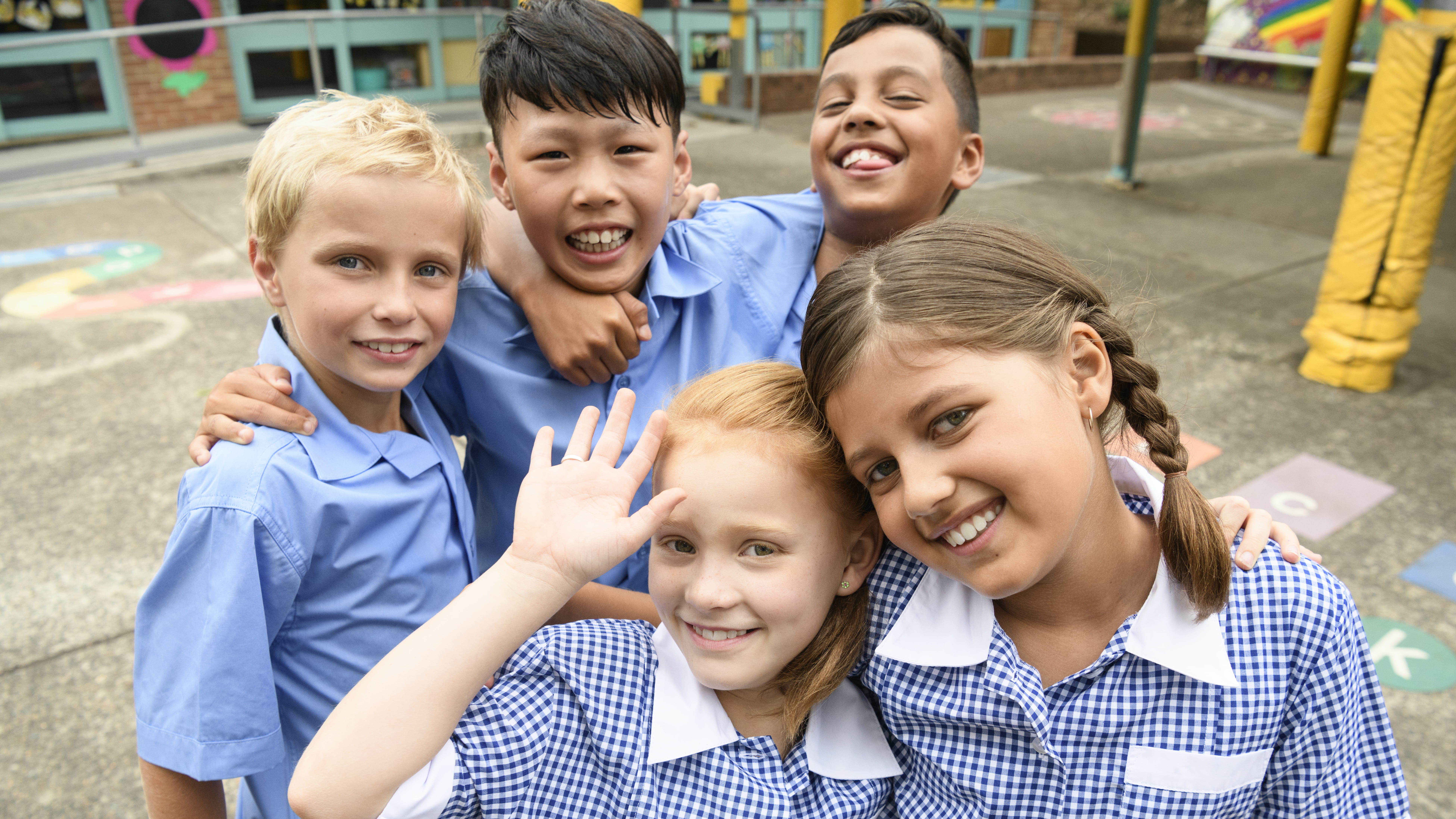 School aged children smiling in their school uniforms