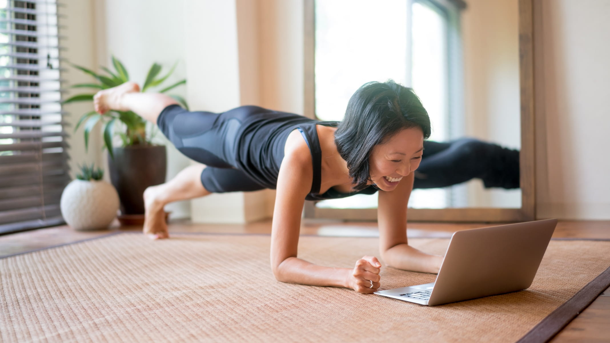 Woman doing yoga at home online