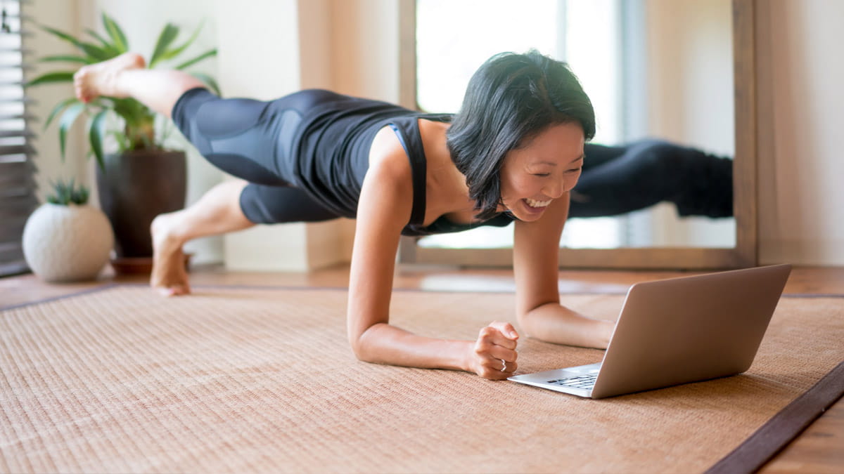 Woman doing exercise in front of her computer