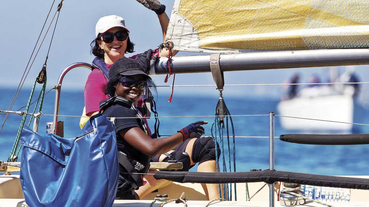 A woman and teenage girl sailing on the ocean