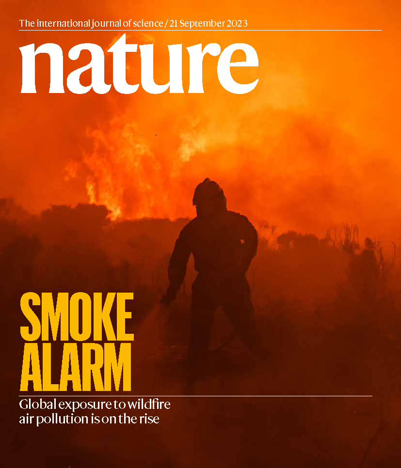 A silhouette of a firefighter against the orange glow of a fire can be seen on the front page of a magazine cover titled 'Nature' 