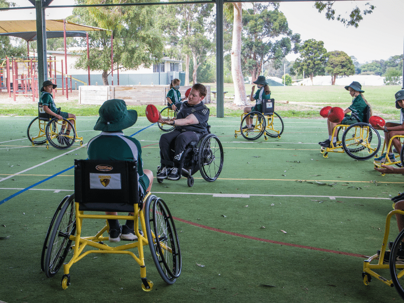 Young students in wheelchairs as part of the Hawks for All program