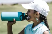 A photo of a person drinking out of a water bottle