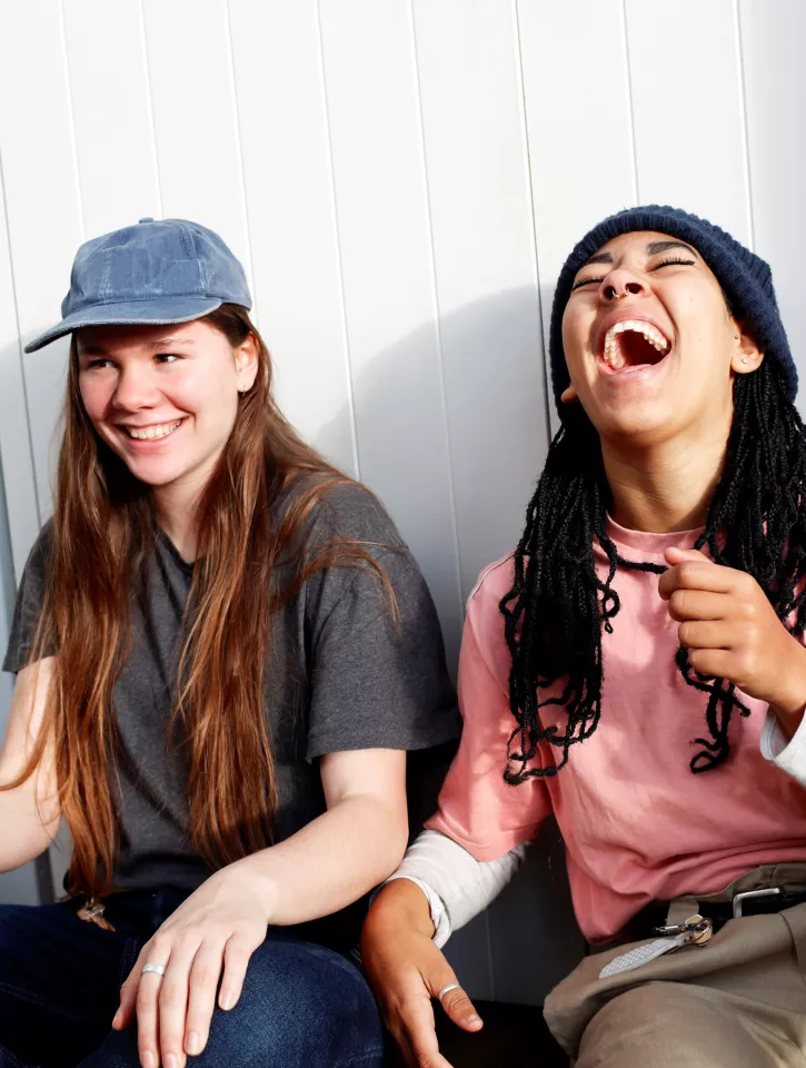 A photo of two young people laughing