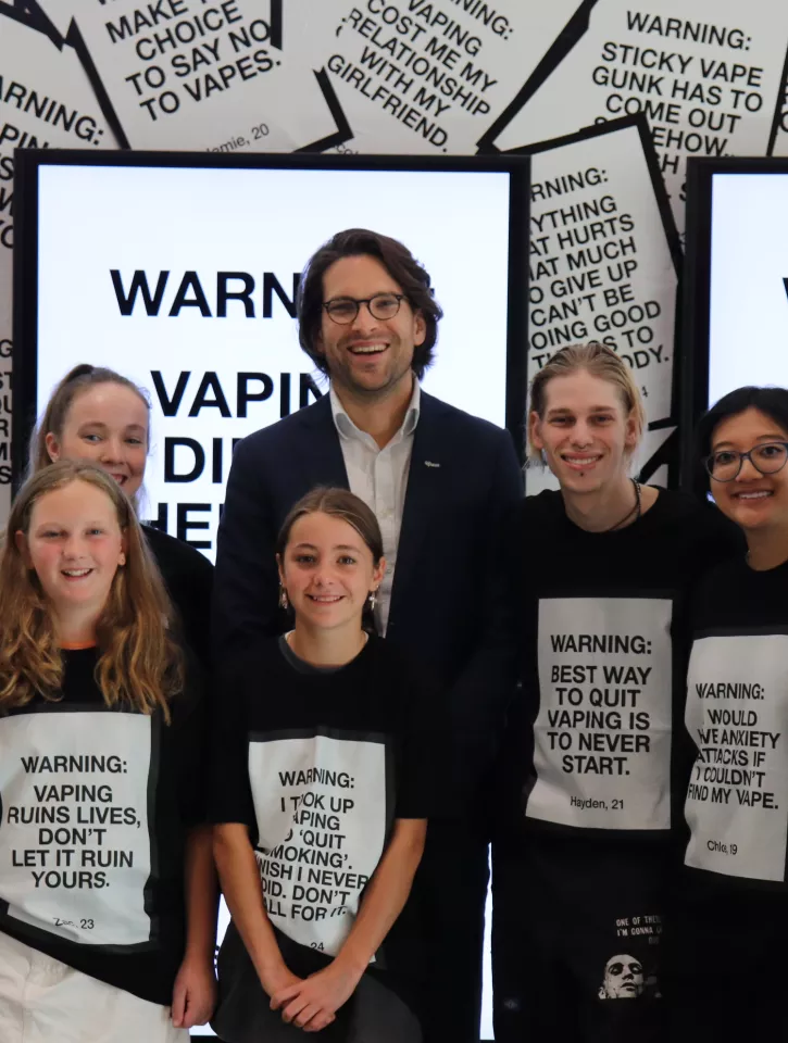 Young people who want to warn others about vaping pose for a photo with VicHealth CEO Dr Sandro Demaio